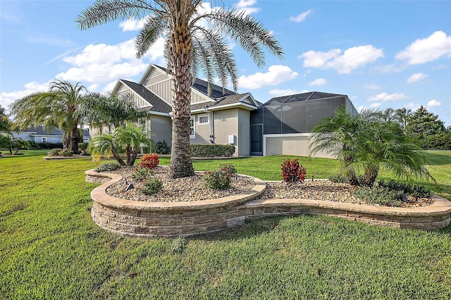 view of front facade featuring a front lawn and a lanai