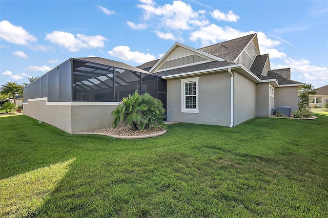 view of property exterior with central AC unit, a lawn, and glass enclosure