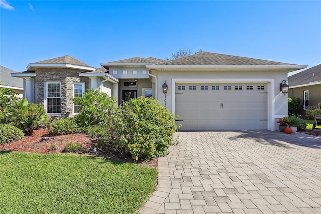 view of front of house with a front yard and a garage