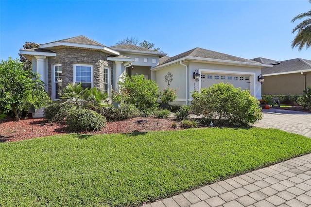 view of front of home with a front lawn and a garage