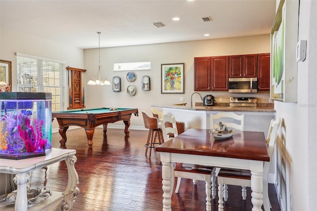 playroom with sink, pool table, an inviting chandelier, and dark hardwood / wood-style flooring