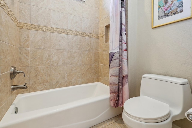 bathroom with toilet, tile patterned floors, and shower / tub combo