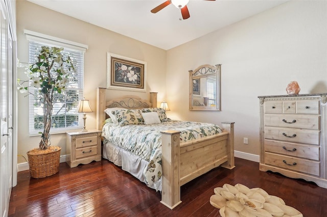 bedroom featuring multiple windows, dark wood-type flooring, and ceiling fan