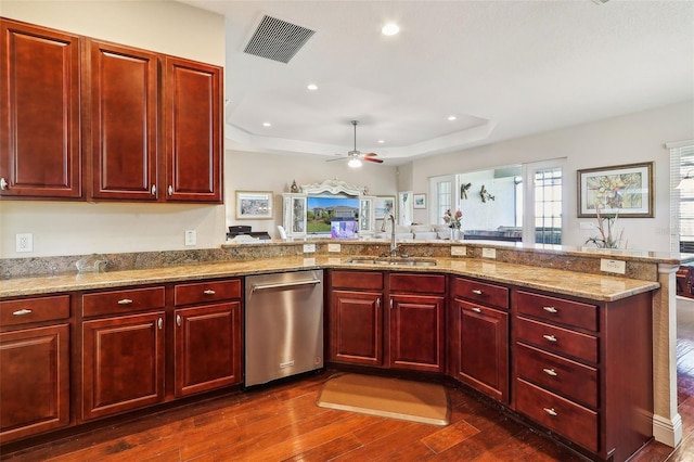 kitchen featuring sink, a raised ceiling, stainless steel dishwasher, light stone counters, and dark hardwood / wood-style flooring