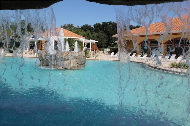 view of pool with a patio and pool water feature