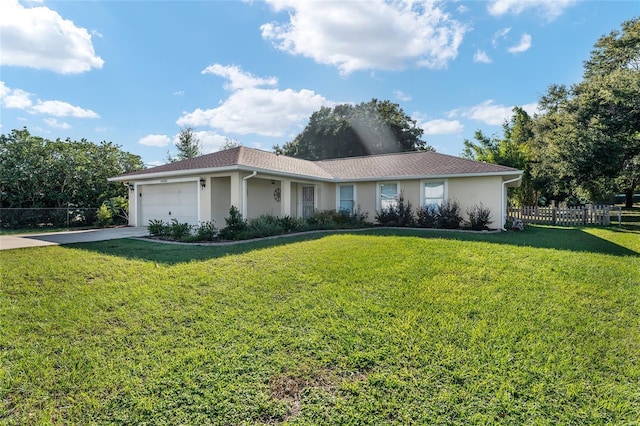 ranch-style house with a garage and a front lawn