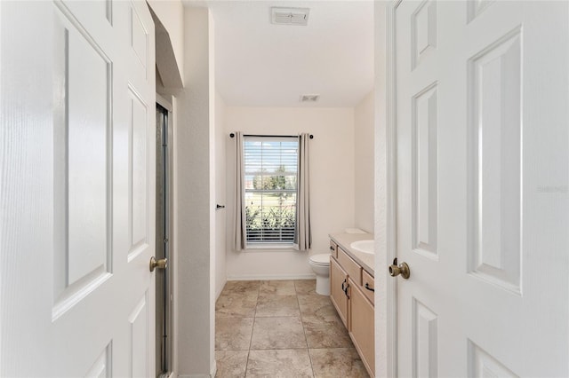 bathroom featuring vanity and toilet