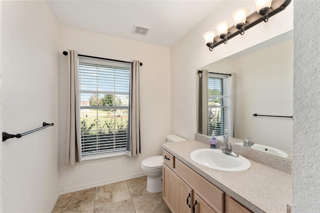 bathroom featuring tile patterned flooring, vanity, and toilet