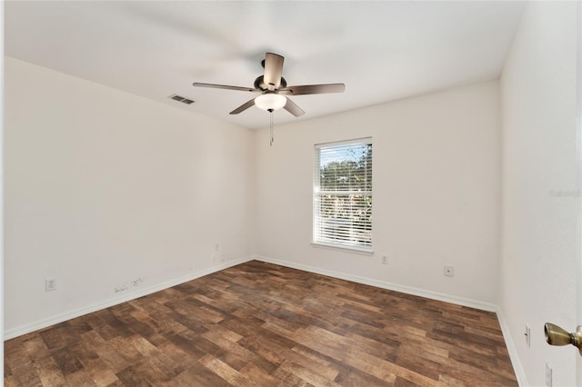 empty room with ceiling fan and dark hardwood / wood-style flooring