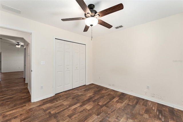 unfurnished bedroom featuring a closet, ceiling fan, and dark hardwood / wood-style flooring