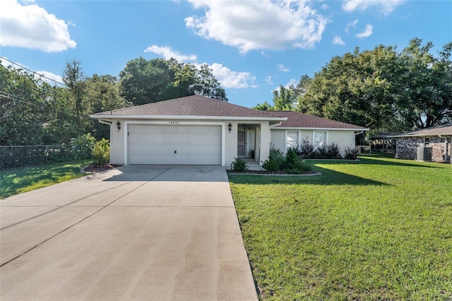 ranch-style home featuring a garage and a front lawn