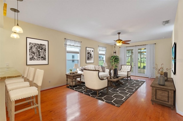 living room featuring dark hardwood / wood-style floors and ceiling fan