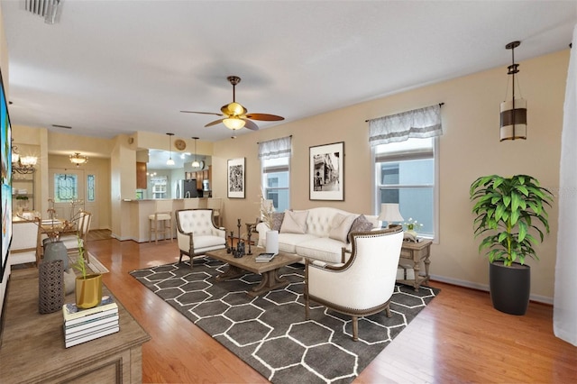 living room featuring wood-type flooring and ceiling fan