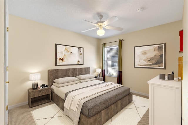 bedroom featuring light colored carpet and ceiling fan