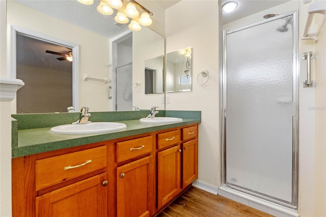 bathroom featuring vanity, an enclosed shower, wood-type flooring, and ceiling fan