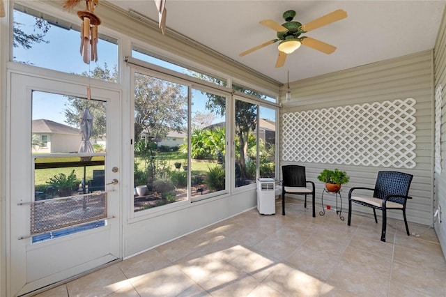 sunroom / solarium featuring ceiling fan and plenty of natural light