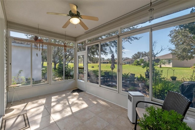 sunroom / solarium featuring ceiling fan