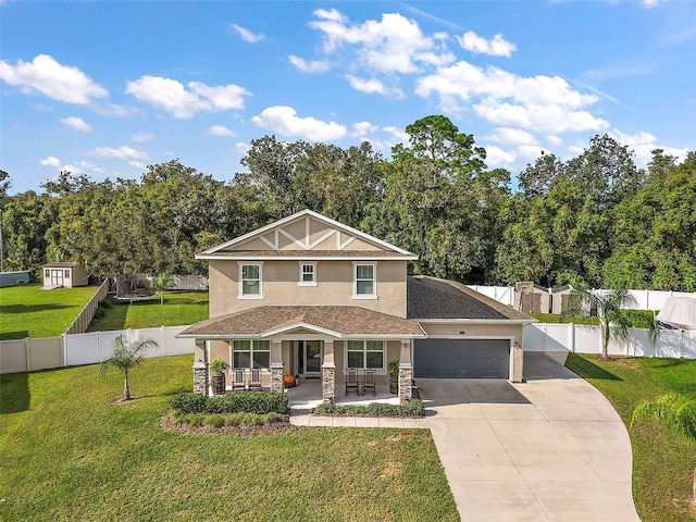 view of front of property featuring covered porch, a garage, and a front yard