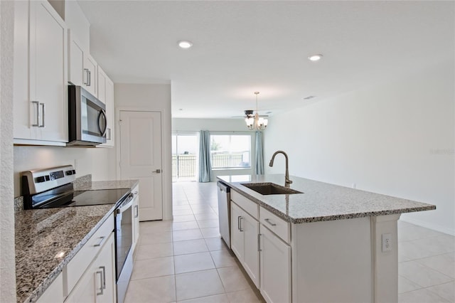 kitchen featuring sink, appliances with stainless steel finishes, a kitchen island with sink, and white cabinetry