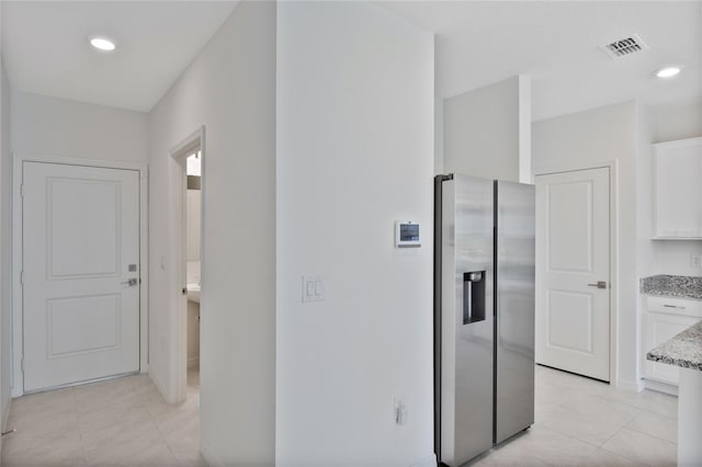 corridor with light tile patterned floors