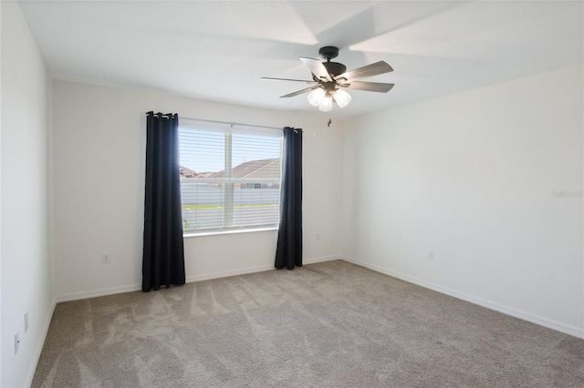 unfurnished room with light carpet and ceiling fan