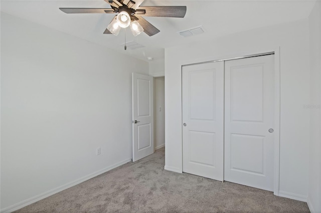unfurnished bedroom featuring light carpet, baseboards, visible vents, a closet, and ceiling fan