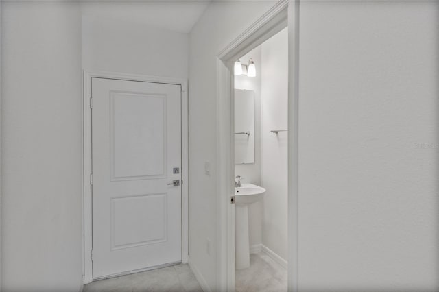 bathroom featuring baseboards and tile patterned flooring