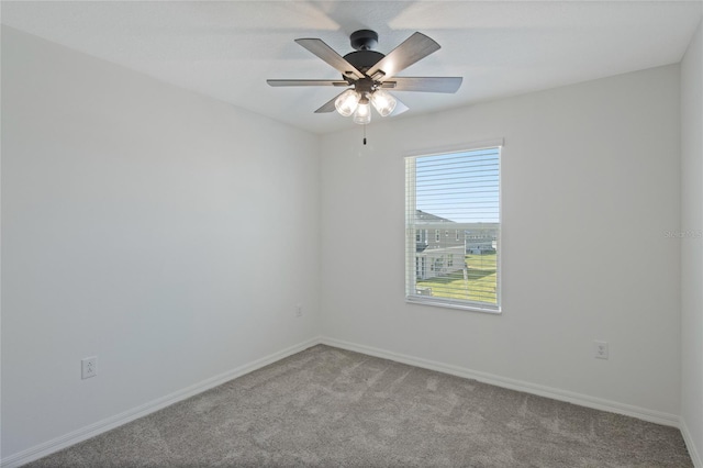 spare room featuring carpet floors, baseboards, and ceiling fan