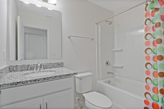 full bathroom with vanity, shower / bath combo, and toilet