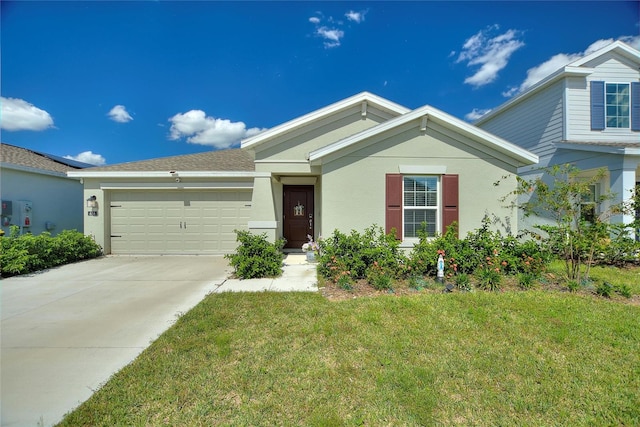 view of front facade with a front yard and a garage