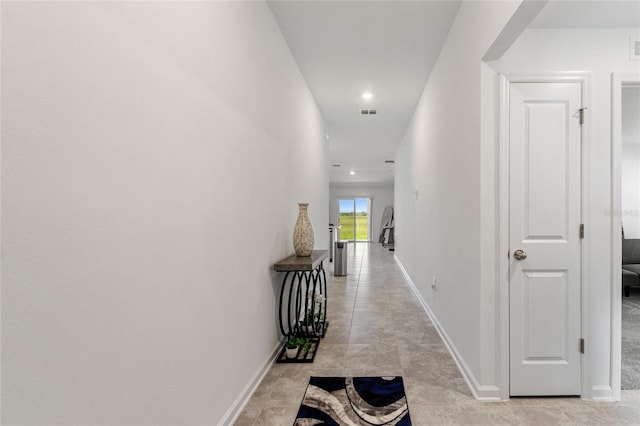 hall featuring light tile patterned flooring