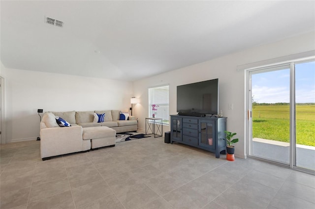 living room featuring a wealth of natural light and light tile patterned flooring