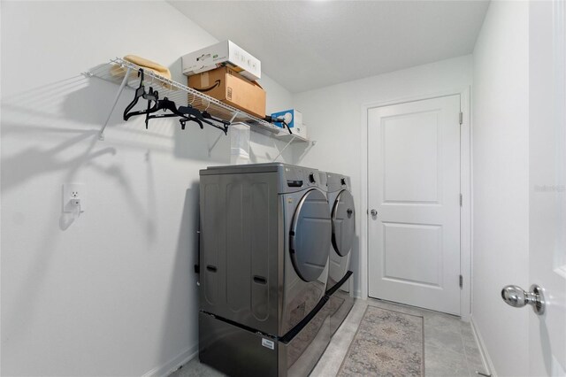 656 Daring Dr, Davenport, FL 33837 - washroom featuring baseboards, laundry area, and washer and clothes dryer