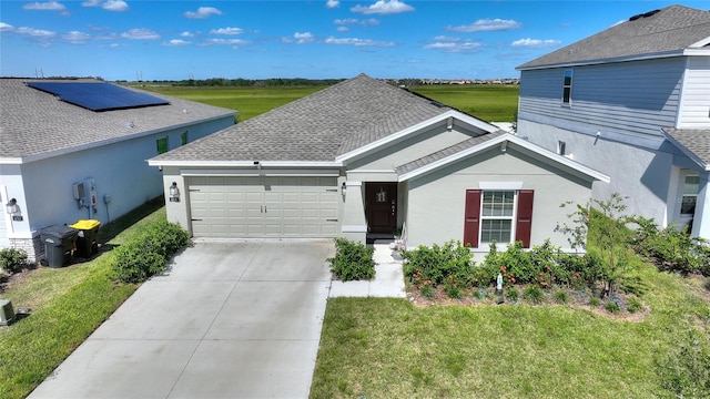 view of front of property with a front yard and a garage