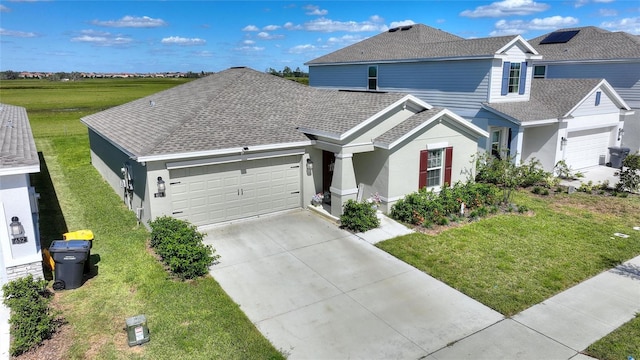 656 Daring Dr, Davenport, FL 33837 - traditional home with a garage, a front yard, stucco siding, a shingled roof, and driveway
