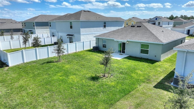 656 Daring Dr, Davenport, FL 33837 - back of house with a lawn, a residential view, central AC, fence, and a shingled roof