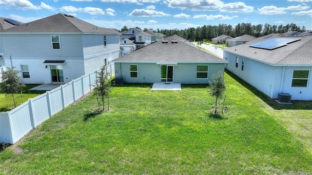 rear view of property featuring a yard, a patio, and cooling unit