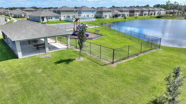 surrounding community with a yard and a water view