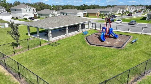 656 Daring Dr, Davenport, FL 33837 - exterior space with a residential view, fence, a lawn, and playground community