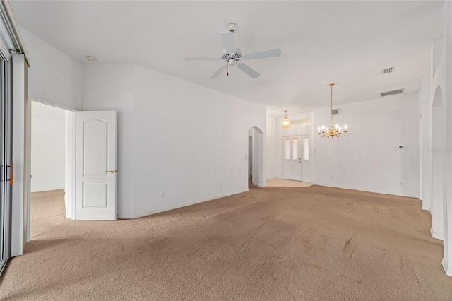 empty room featuring light colored carpet and ceiling fan with notable chandelier