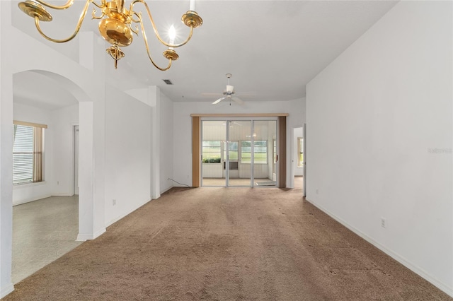 carpeted empty room with ceiling fan with notable chandelier