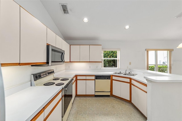 kitchen with kitchen peninsula, sink, vaulted ceiling, white cabinetry, and white appliances