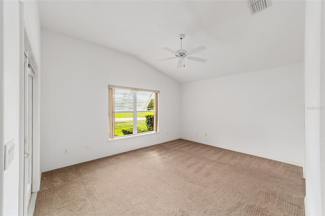 empty room with ceiling fan, vaulted ceiling, and carpet floors