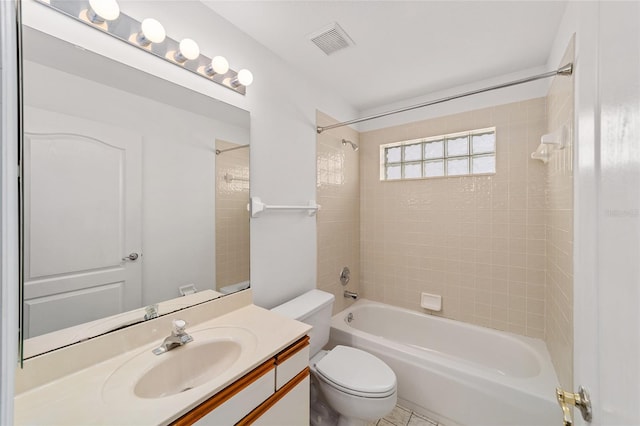 full bathroom with toilet, tiled shower / bath, vanity, and tile patterned flooring