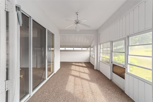 unfurnished sunroom with ceiling fan