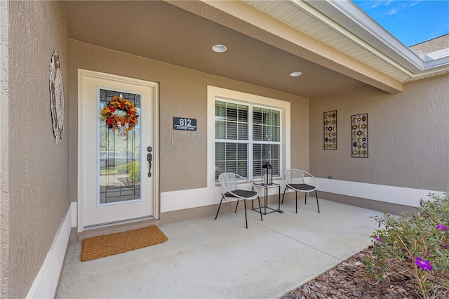 property entrance featuring a patio