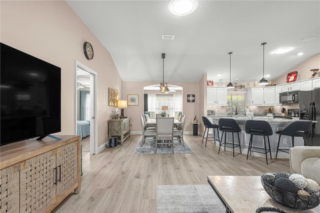 living room featuring light hardwood / wood-style flooring and lofted ceiling