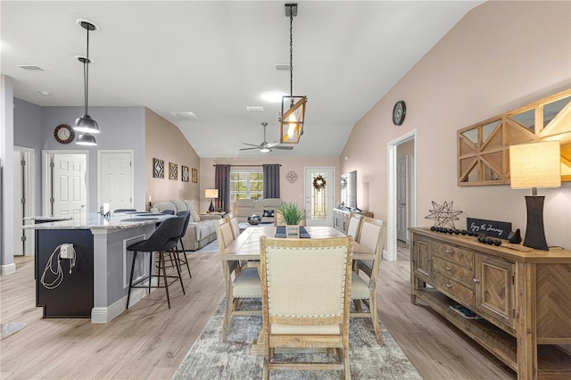 dining room featuring vaulted ceiling, light wood-type flooring, and ceiling fan