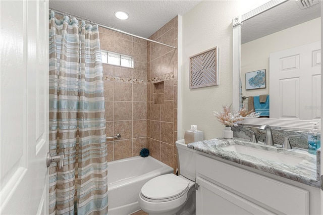 full bathroom featuring vanity, a textured ceiling, shower / bath combo with shower curtain, and toilet