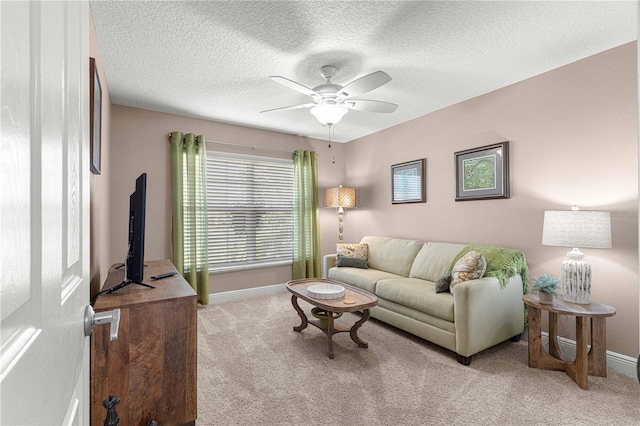 living room featuring light carpet, a textured ceiling, and ceiling fan